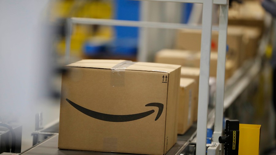 Image: Boxes move down a conveyor belt during a tour of the Amazon fulfillment center Thursday, May...