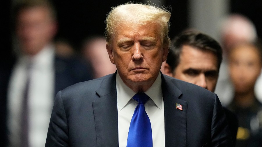 Image: Former President Donald Trump walks to make comments to members of the media after a jury co...