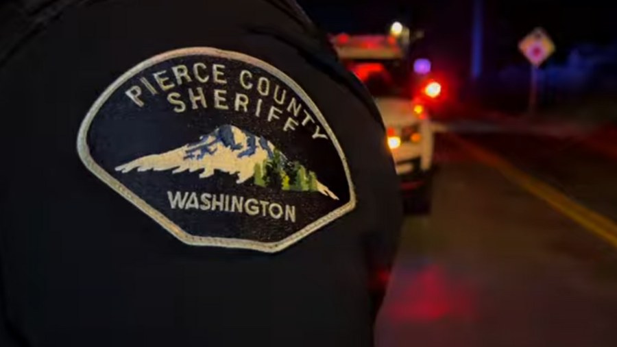 Image: A Pierce County Sheriff's Department logo can be seen on an officer at a scene with a police...