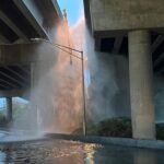 Water spewing from a burst pipe underneath Highway 99 in Seattle’s South Park neighborhood. (Photo: Sam Campbell, KIRO Newsradio)