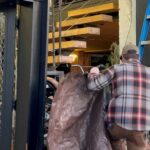 An employee covering the damages the storefront received overnight. (Photo: Sam Campbell, KIRO Newsradio)