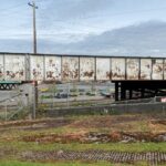 Image: Hewitt Avenue used to travel beneath the railroad bridge, with east and westbound lanes separated by a divider; it was the main route to and from the waterfront and City Dock for much of the 20th century.